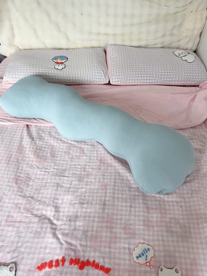 Buyer photo of the wave body pillow on a bed